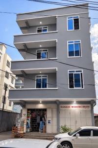 a large white building with a store in front of it at Al-mendhiry Apartment in Zanzibar City