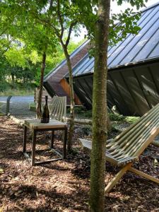 two chairs and a table in front of a house at Cabin Balaton in Vonyarcvashegy