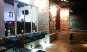 a living room with a couch and a large window at The Villa Rochelle Kandy in Kandy +20 photos