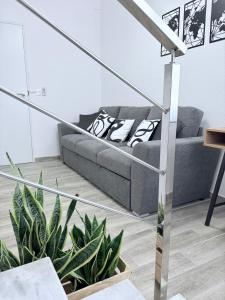 a living room with a couch and some plants at Apartamento en Lorca Murcia in Lorca +14 photos