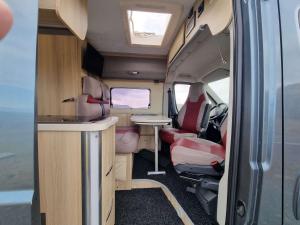 an interior view of an rv with a table and chairs at Adventure Campervan to Explore the Faroes in Hoyvík +46 photos