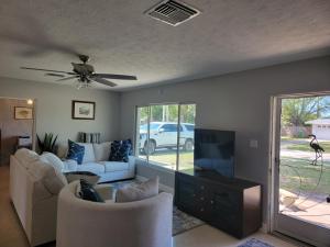 a living room with a couch and a flat screen tv at Manatee River Bungalows - 2 in Bradenton