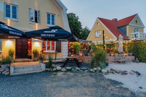 a house with an outdoor patio with umbrellas at Strandidyl Bed and Breakfast in Haderslev