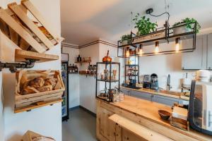 two images of a kitchen with a counter with bread at Strandidyl Bed and Breakfast in Haderslev
