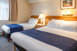 a hotel room with two beds and a window at Carrington House Hotel in Bournemouth