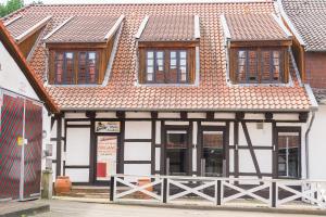 a building with four windows and a roof at Hotel Stadtherz in Burgwedel