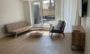 a living room with a couch and a chair and a table at Superior Apartment mit 1 Schlafzimmer in Hildesheim