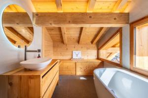 a bathroom with a white sink and a tub at Chalet BO'M in Le Grand-Bornand +44 photos
