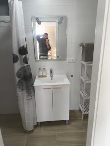 a bathroom with a white sink and a mirror at Casa Campo Gerena in Sanlúcar de Barrameda