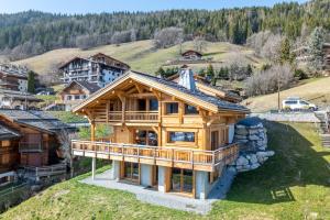 a large wooden house on top of a hill at Chalet BO'M in Le Grand-Bornand