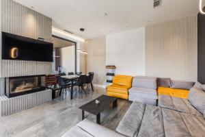 a living room with a couch and a fireplace at Villa AMMA Pool & Jacuzzi by PikHost in Draç