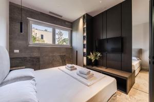 a bedroom with a bed and a flat screen tv at Villa AMMA Pool & Jacuzzi by PikHost in Draç +92 photos