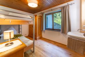 a bedroom with a bunk bed and a sink at Ferienhaus am Waldrand in Damuls