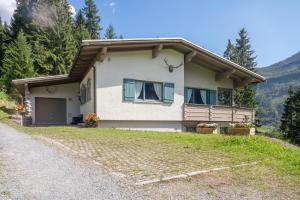a house on the side of a road at Ferienhaus am Waldrand in Damuls +5 photos