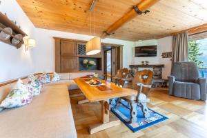 a living room with a couch and a table at Ferienhaus am Waldrand in Damuls