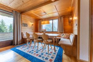 a dining room with a table and chairs at Ferienhaus am Waldrand in Damuls