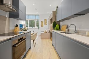 a kitchen with a sink and a counter top at Modern 2 Bed Apartment by MCF in Merstham
