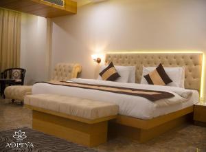 a bedroom with a large bed in a room at Hotel Aditya Residency in Bhopal