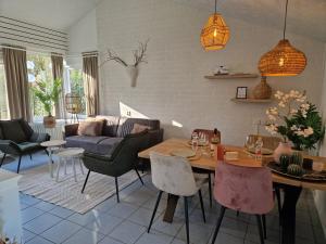 a living room with a table and chairs at Puur 38 in Simpelveld