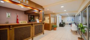 an office lobby with a reception counter and a waiting room at Ozlem Garden Hotel in Side