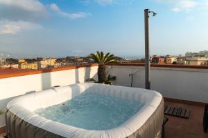 a hot tub on a balcony with a view at Terrazza vista Vesuvio e Capri con Jacuzzi privata in Naples
