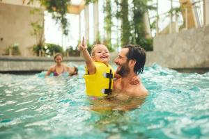 a man and a child in a swimming pool at Center Parcs Nordborg Resort in Nordborg