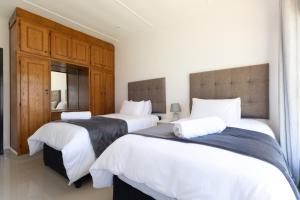 a bedroom with two beds with white sheets at Windsor Place by First Private Stays in Margate
