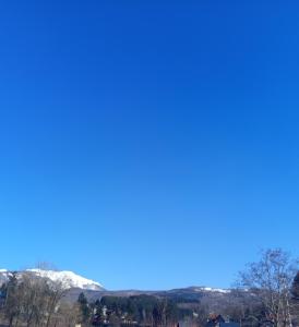 a view of snow covered mountains from the top of the hill at GUESTHOUSE TARA in Kolašin +7 photos