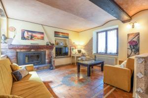 a living room with a couch and a fireplace at Italian Experience-Casale Dolcemare in Campofilone
