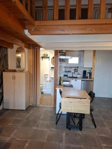 a kitchen and dining room with a table in a room at Appartament prés de la mer in Valras-Plage +18 photos