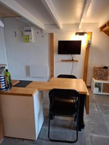 a kitchen with a wooden table and two chairs at Appartament prés de la mer in Valras-Plage