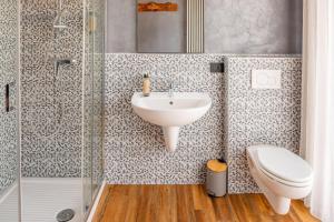 a bathroom with a sink and a toilet and a shower at La Pacheca Rock Apartments in Lazise +64 photos