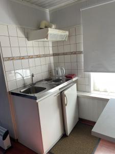 a small kitchen with a sink and a stove at Beau-sejour in Francorchamps