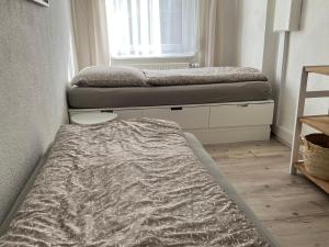 a bedroom with two beds and a window at house46-1 in Hohen Neuendorf