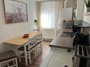 a kitchen with a wooden table and a dining room at house46-1 in Hohen Neuendorf +4 photos