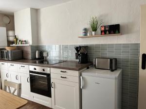 a kitchen with white cabinets and a counter top at house46-1 in Hohen Neuendorf