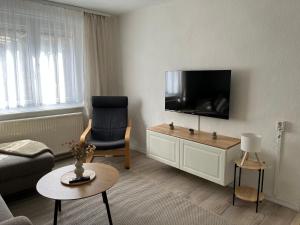 a living room with a flat screen tv on a wall at house46-1 in Hohen Neuendorf