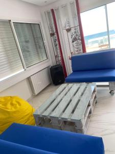 a room with two blue chairs and a table at Villa Sassi in Nabeul