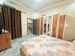 a bedroom with a large bed and a large mirror at House & Food in Thiès
