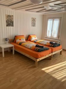 a bedroom with two beds in a room at 22 - Gästehaus Erika - Hundwil - Appenzellerland in Hundwil