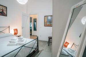a bedroom with a bed and a mirror at Villa Michaela con piscina privata e vista mare in Capo Vaticano +38 photos