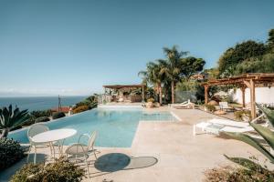 a villa with a swimming pool with a view of the ocean at Villa Michaela con piscina privata e vista mare in Capo Vaticano