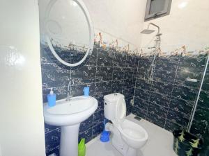 a bathroom with a sink and a toilet and a mirror at House & Food in Thiès +22 photos