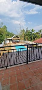 a view of a swimming pool behind a fence at Kingfisher House in Sangkhla Buri +23 photos