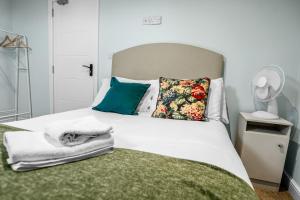 a bedroom with a bed with towels on it at Family-Friendly Chorlton Apartment with Free Street Parking in Sale