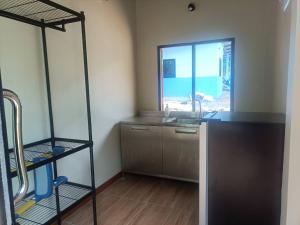 a room with a kitchen with a sink and a window at Than Khao Nature Resort and Homestay - Krabi Noi in Krabi