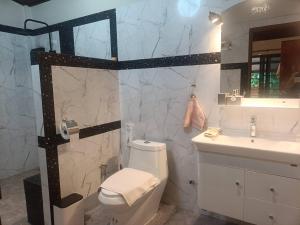 a bathroom with a white toilet and a sink at Than Khao Nature Resort and Homestay - Krabi Noi in Krabi +25 photos
