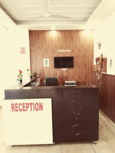 an office with a reception desk with a sign at Hotel Red ark inn in Mohali