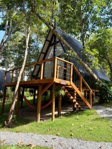 a tree house with a slide in a park at Chalé Malbec, Estrada do Vinho com cafe da manha e hidro in São Roque