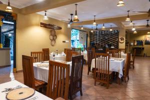 a dining room with tables and chairs in a restaurant at The Maridadi Hotel in Moshi